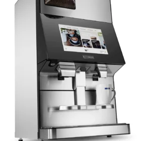 Wittenborg w100 kaffemaskin har et elegant design med en digital berøringsskjerm og to dispensere. Kaffebønner er synlige i det øverste rommet, mens et hvitt krus venter under dispenserne.