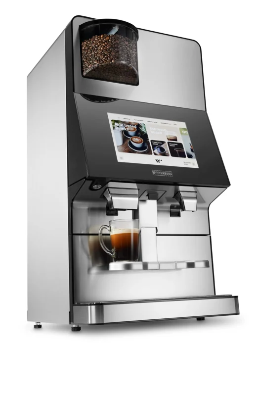 Opplev Wittenborg w100 kaffemaskin, en elegant kaffemaskin med digitalt display som brygger den perfekte koppen kaffe. Med en trakt fylt med bønner på toppen og en elegant metall og svart design, er det den ideelle blandingen av stil og funksjonalitet.