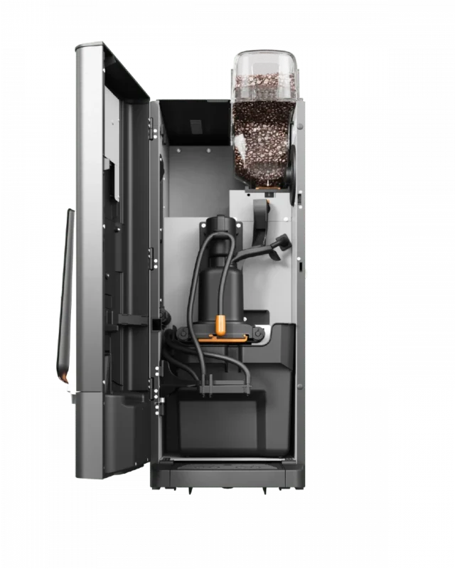 Innvendig visning av en kaffemaskin som viser bønnebeholderen fylt med kaffebønner, interne slanger, en pumpe og diverse mekaniske komponenter.