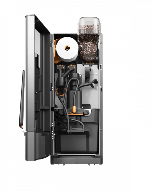 Bildet viser innsiden av en kaffemaskin med synlige komponenter, inkludert rør, en papirrull og en bønnebeholder fylt med kaffebønner.