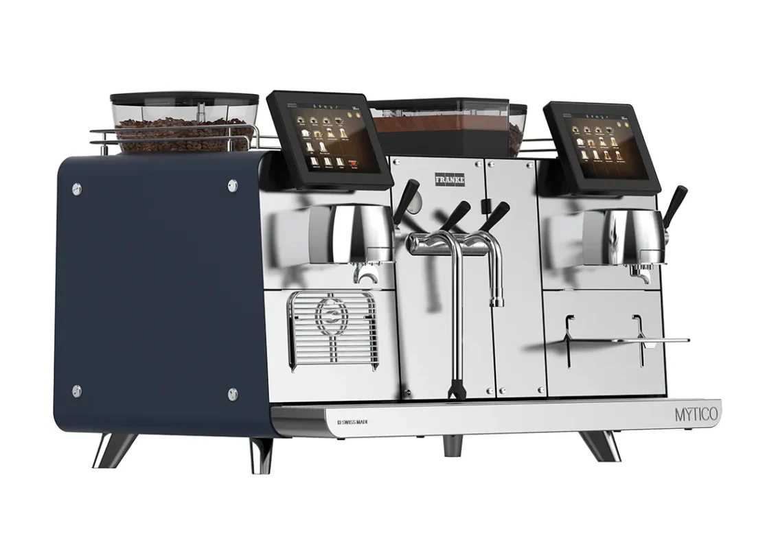 En moderne, kommersiell espressomaskin med to bryggegrupper, berøringsskjerm, dampstav og kaffebønnebeholdere på hver side.